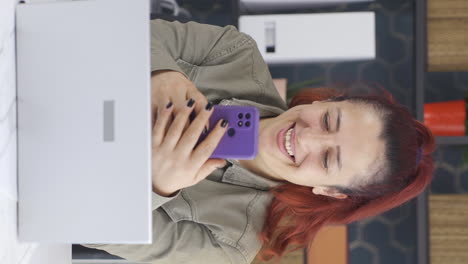 Vertical-video-of-Happy-business-woman-using-phone-laughing.